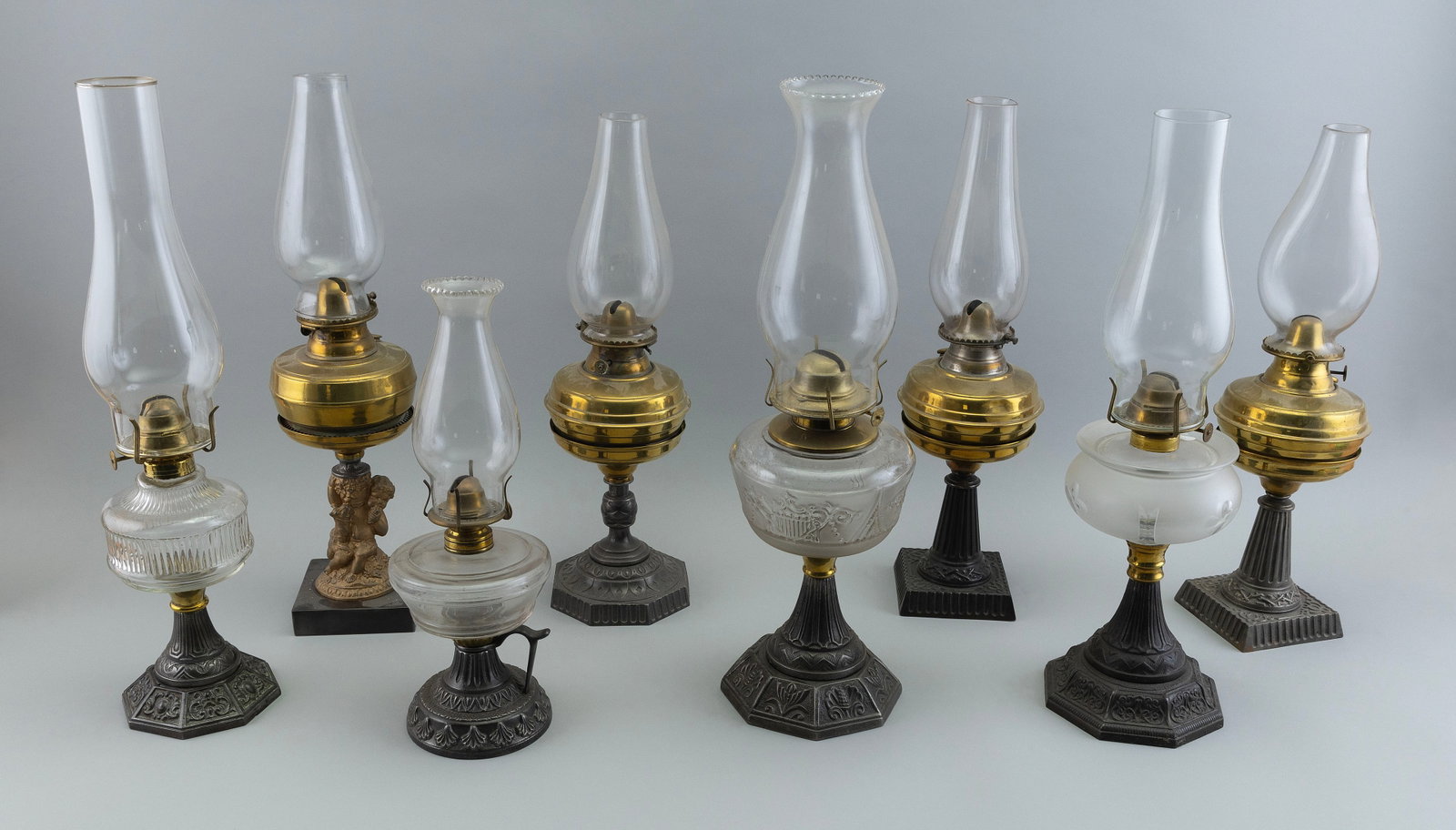 EIGHT FLUID LAMPS 19th Century Heights to collar from 6" to 10.25".: EIGHT FLUID LAMPS 19th Century All with glass chimneys, glass and brass fonts and metal bases. Heights to collar from 6" to 10.25".