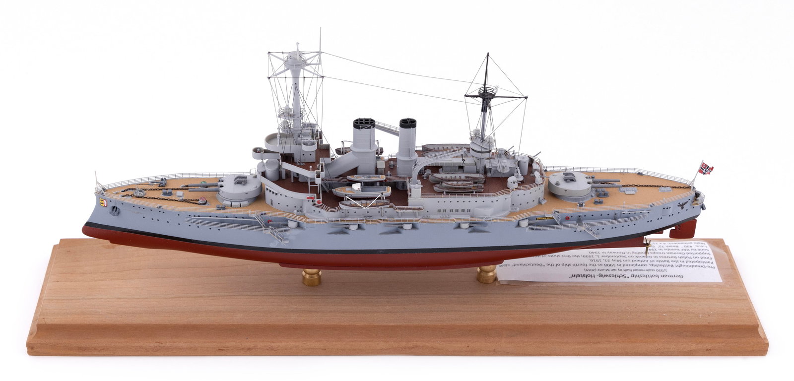 MODEL OF THE GERMAN BATTLESHIP "SCHLESWIG-HOLSTEIN" 21st Century Height 7". Total length 16.5".: MODEL OF THE GERMAN BATTLESHIP "SCHLESWIG-HOLSTEIN" 21st Century By Jan Muntz. Made of plastic. Displayed on brass pedestals on a wooden base. Height 7". Total length 16.5".