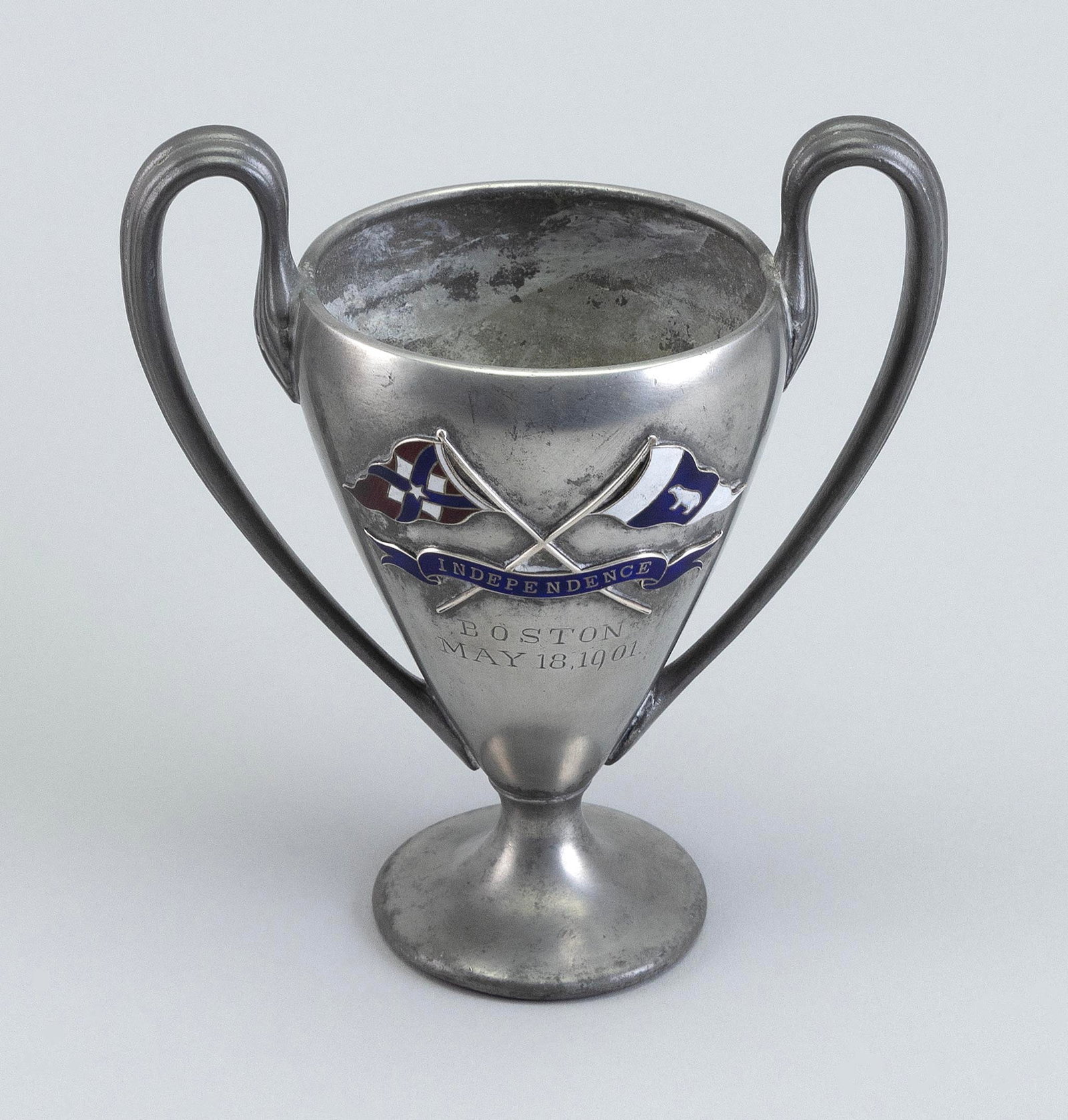 SILVER PLATED TROPHY COMMEMORATING THE LAUNCH OF THOMAS LAWSON'S YACHT "INDEPENDENCE" Circa 1901: SILVER PLATED TROPHY COMMEMORATING THE LAUNCH OF THOMAS LAWSON'S YACHT "INDEPENDENCE" Circa 1901 Engraved "Boston May 18, 1901" below enameled crossed burgees and "Independence" banner. The Independen