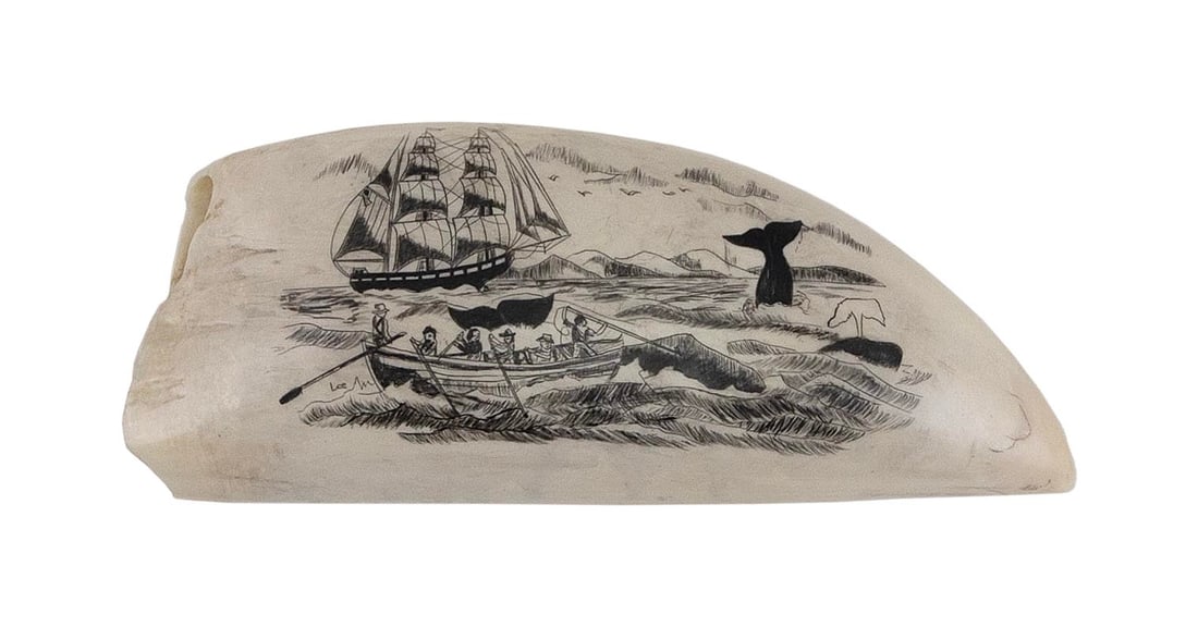 * ENGRAVED WHALE'S TOOTH WITH WHALING SCENE 20th Century Length 5.75".: * ENGRAVED WHALE'S TOOTH WITH WHALING SCENE 20th Century Coastal whaling scene with a whaleboat in the foreground harpooning a whale, and other surfaced whales and a whaleship in the distance. Signed 