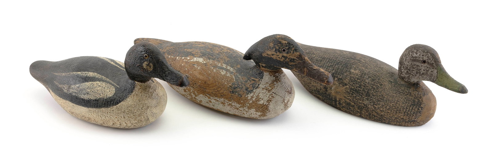 THREE FACTORY DECOYS Early 20th Century Lengths 14", 17" and 18".: THREE FACTORY DECOYS Early 20th Century A merganser, a goldeneye and a black duck. Lengths 14", 17" and 18".
