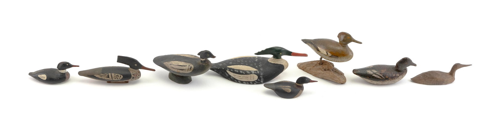 EIGHT MINIATURE MERGANSER CARVINGS 20th Century Lengths from 3.5" to 7.5".: EIGHT MINIATURE MERGANSER CARVINGS 20th Century Includes one by Willie Ross (Chebeague Island, Maine, 1878-1954), one unpainted and two in standing position. Lengths from 3.5" to 7.5".