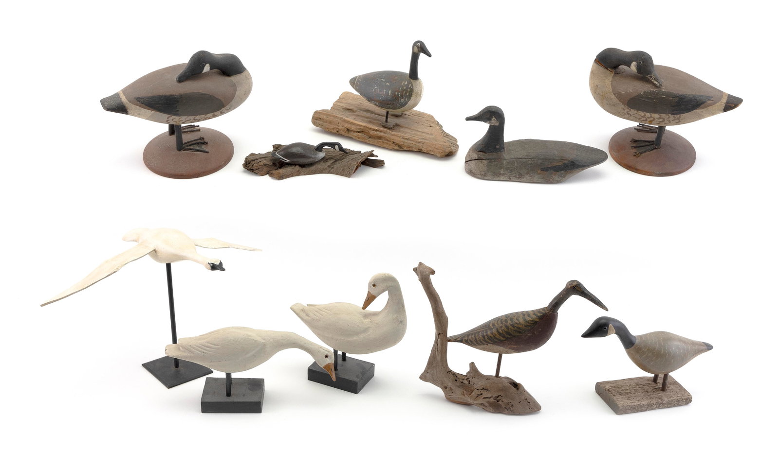 TEN MINIATURE BIRD CARVINGS 20th Century Lengths from 5.5" to 6".: TEN MINIATURE BIRD CARVINGS 20th Century Two snow geese, a swan in flying form, a heron and six Canada geese. Canada geese include two by Charles Torry, one by Roger Howland, two unmarked and one mark