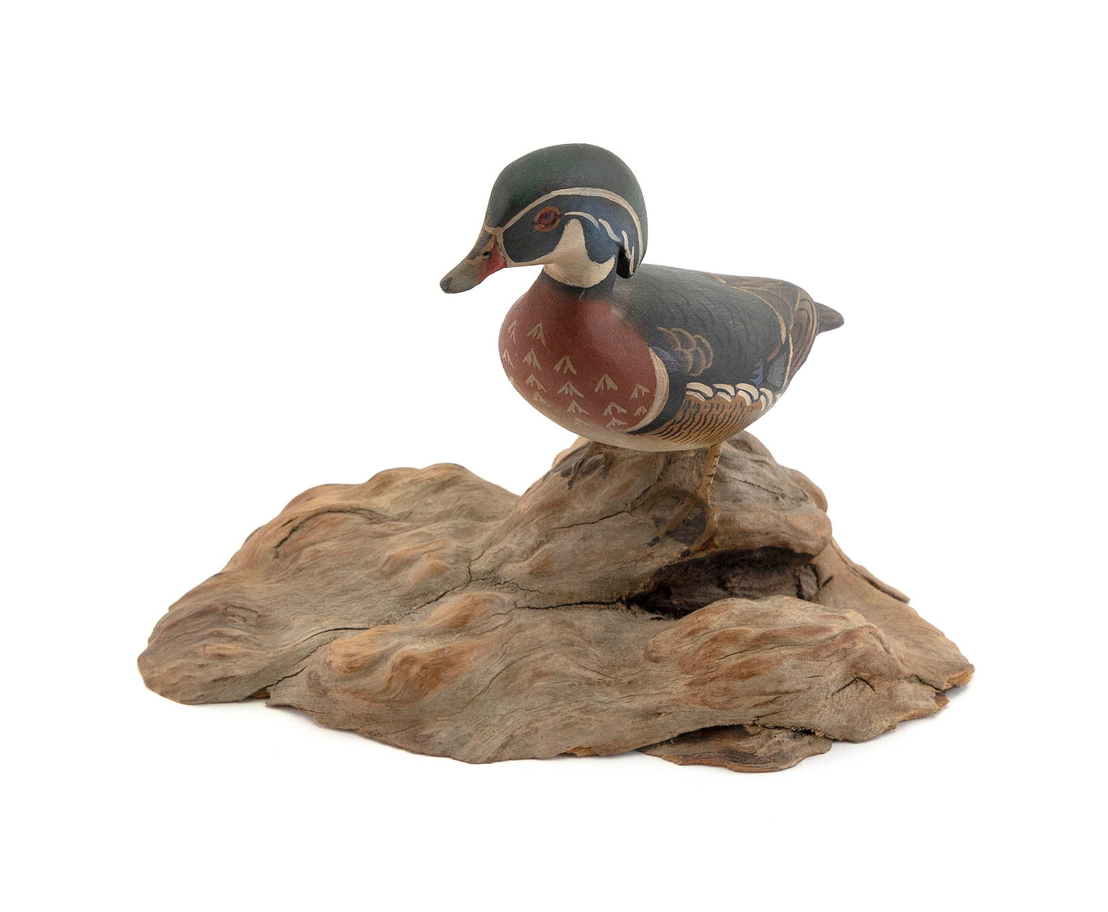 JAMES LAPHAM MINIATURE WOOD DUCK DRAKE CARVING Dennis Port, Massachusetts, 1909-1987 Height 5".: JAMES LAPHAM MINIATURE WOOD DUCK DRAKE CARVINGDennis Port, Massachusetts, 1909-1987Mounted on a driftwood base. Signed on underside of base.Height 5".