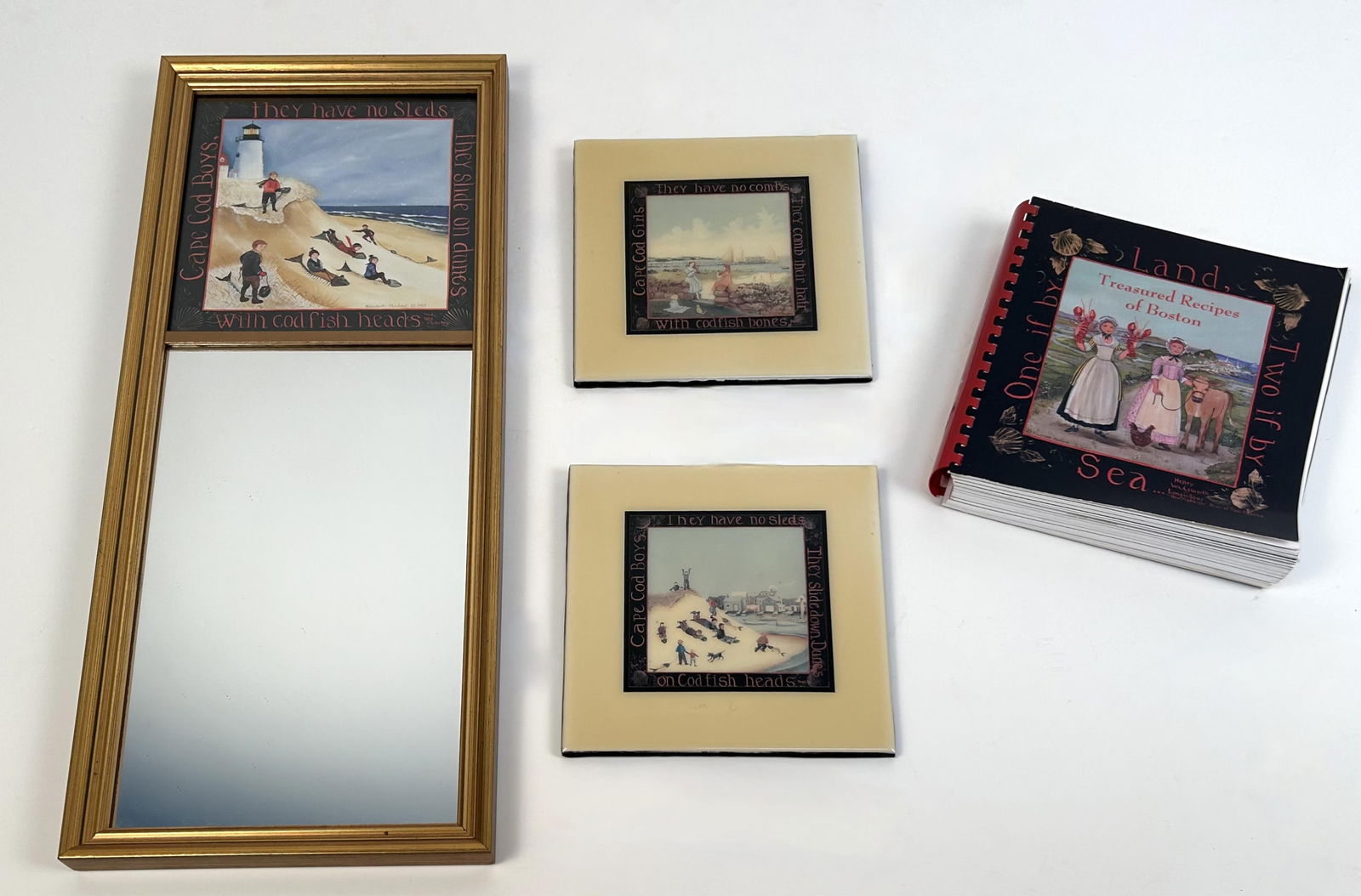 ELIZABETH MUMFORD (Massachusetts, 1950-2020), A cookbook with the cover illustration by Mumford, two: ELIZABETH MUMFORDMassachusetts, 1950-2020A cookbook with the cover illustration by Mumford, two trivets with Mumford illustrations and a tabernacle mirror with a Mumford print in the upper panel. Mirr