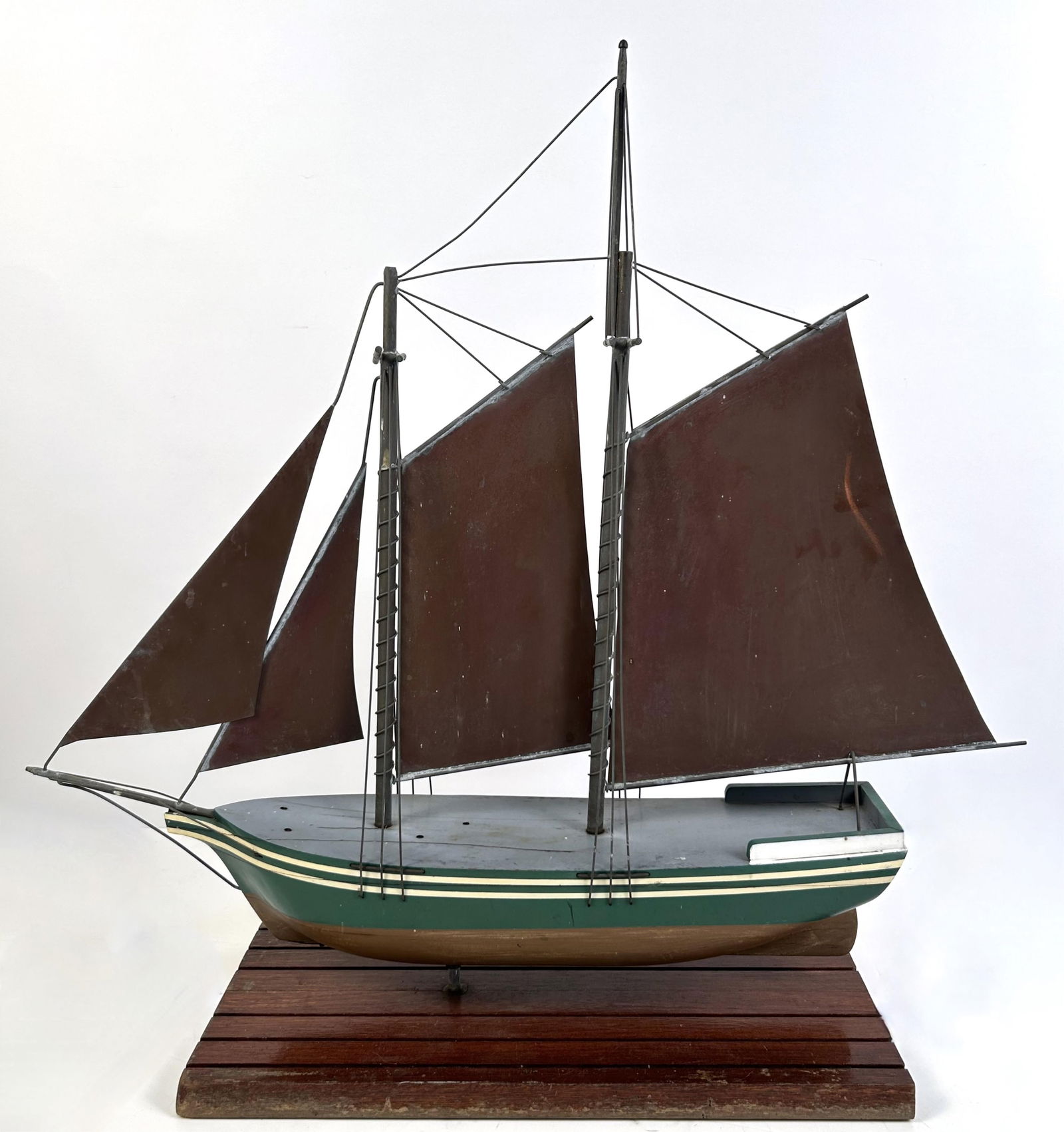 SHIP WEATHER VANE 20th Century Length 30". Displayed on a wooden stand.: SHIP WEATHER VANE20th CenturyWith copper sails and a wooden hull.Length 30". Displayed on a wooden stand.