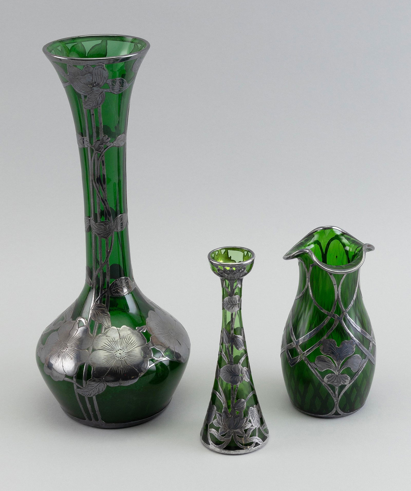 THREE SILVER OVERLAY GREEN GLASS VASES Late 19th Century Heights from 6" to 12". (1 of 3)