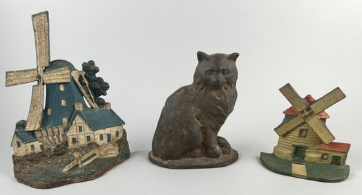 THREE CAST IRON DOORSTOPS Early 20th Century Heights from 7" to 12".