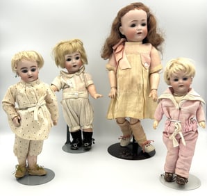 FOUR GERMAN BISQUE-HEAD DOLLS Circa 1910 Heights from 8" to 13".
