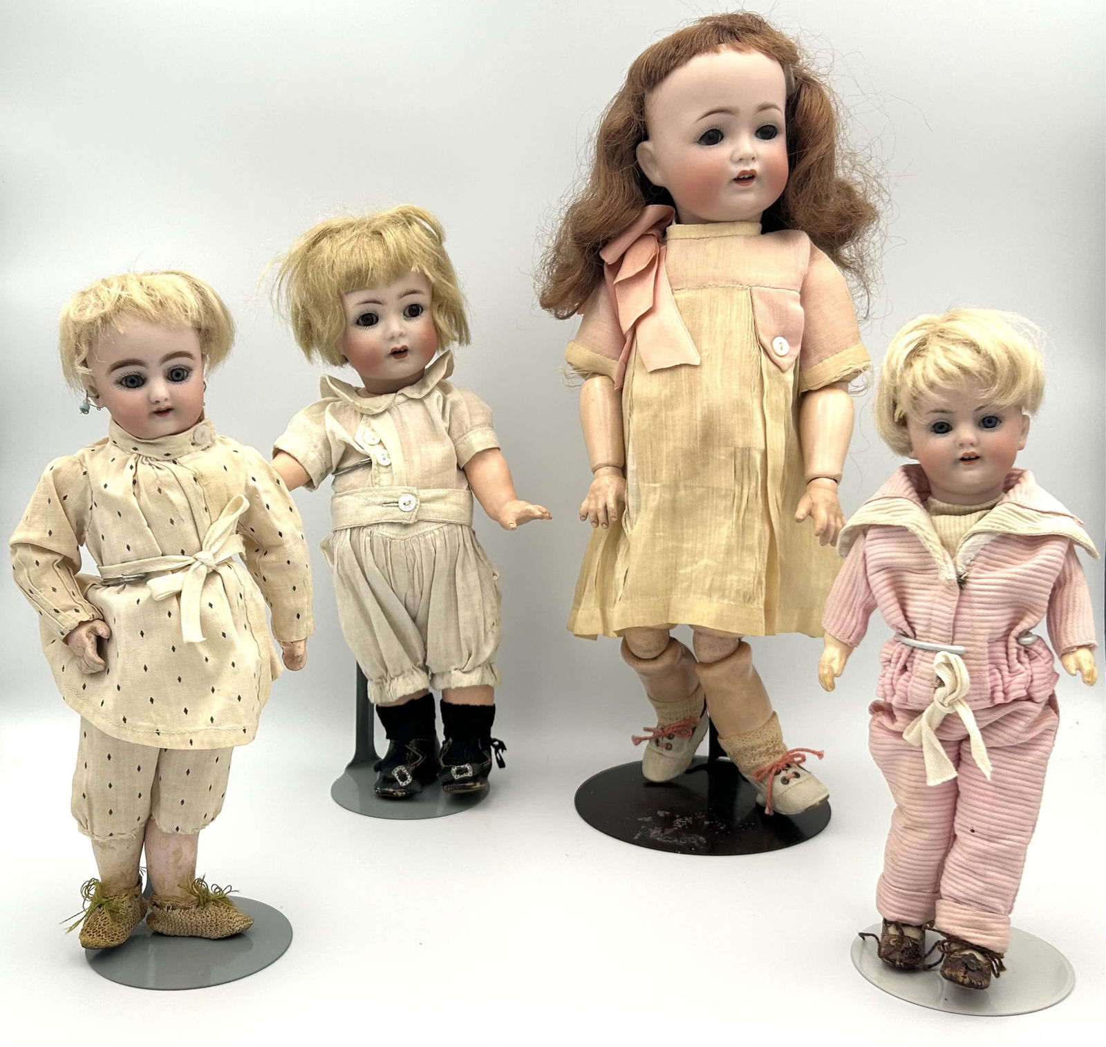 FOUR GERMAN BISQUE-HEAD DOLLS Circa 1910 Heights from 8" to 13". (1 of 12)