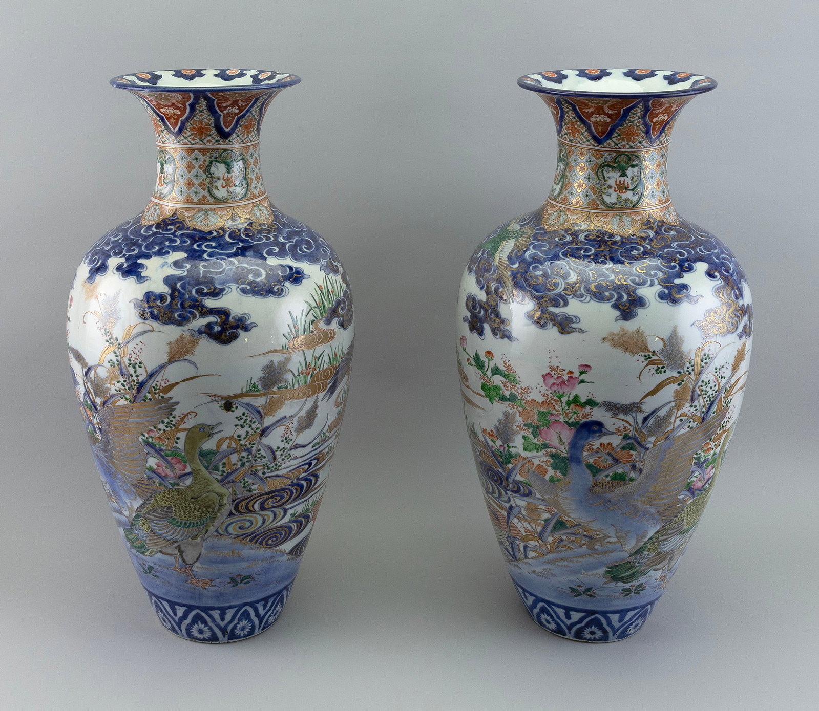 PAIR OF JAPANESE SATSUMA PORCELAIN TEMPLE VASES Late Meiji Period, Early 20th Century Heights 24".: PAIR OF JAPANESE SATSUMA PORCELAIN TEMPLE VASES Late Meiji Period, Early 20th Century Gilt-highlighted bodies decorated with geese and other birds in a landscape. Flared mouths with lappet and dragon 