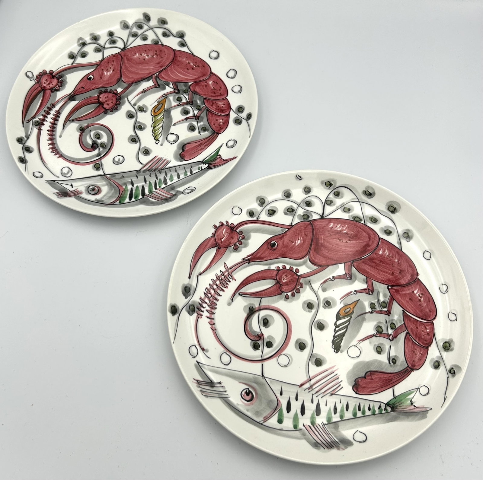PAIR OF MANCIOLI FISH AND SHELLFISH PLATES Italy, Circa 1960s Diameters 10".: PAIR OF MANCIOLI FISH AND SHELLFISH PLATES Italy, Circa 1960s Labeled on base "Made in Italy expressly for Neiman Marcus 8/553". Diameters 10".