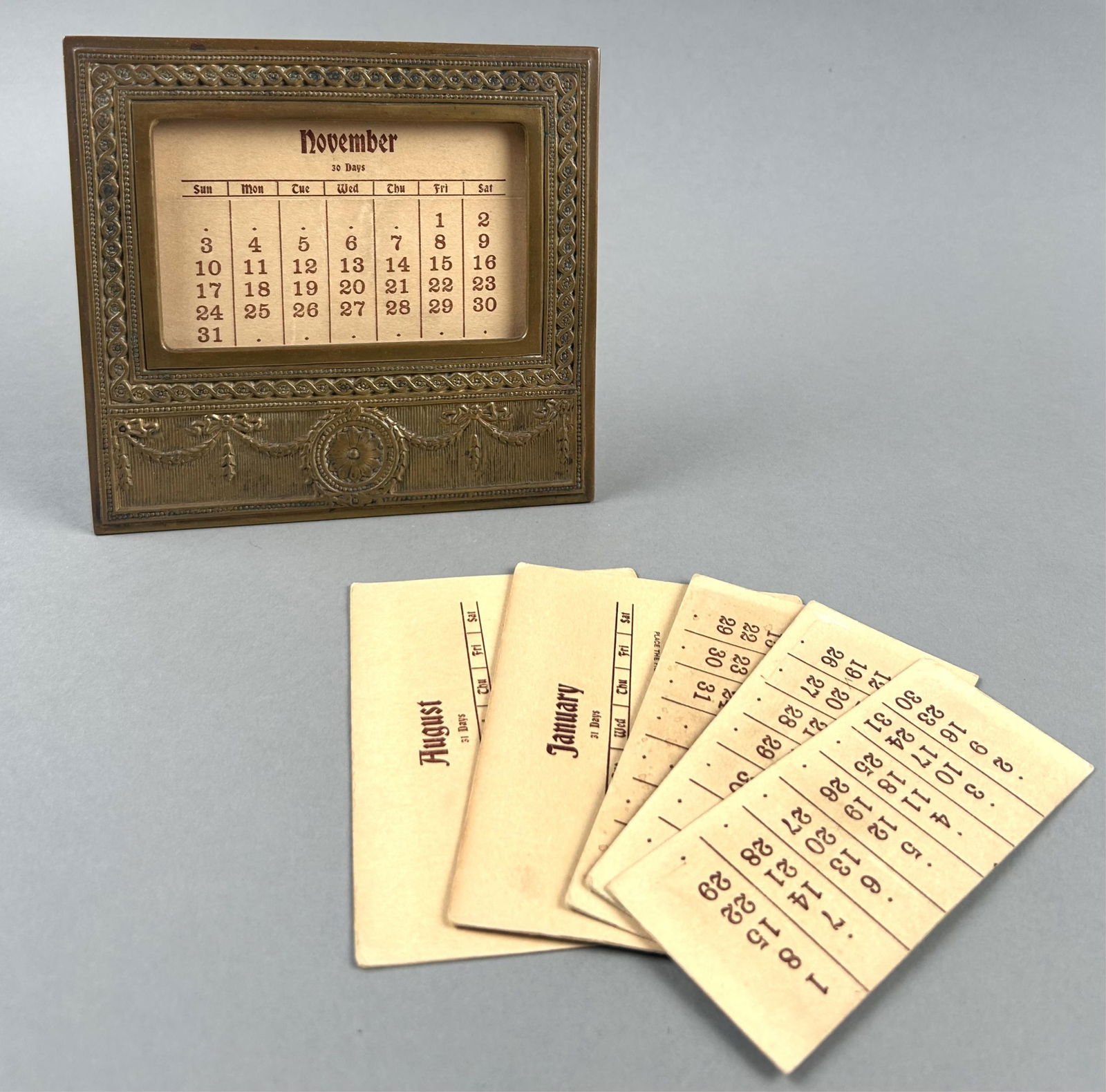 TIFFANY STUDIOS "ADAM" GILT BRONZE DESK CALENDAR New York, Early 20th Century Height 6". (1 of 3)