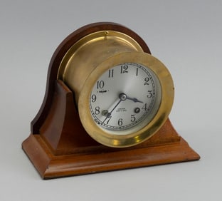 CHELSEA CLOCK CO. SHIP'S BELL CLOCK ON STAND Boston, 20th Century Height 6". Dial diameter 3.75".