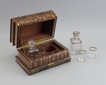 FAUX BOOK CAVE A LIQUEUR DECANTER SET Mid-20th Century Height 5". Width 8.75". Depth 5.5".