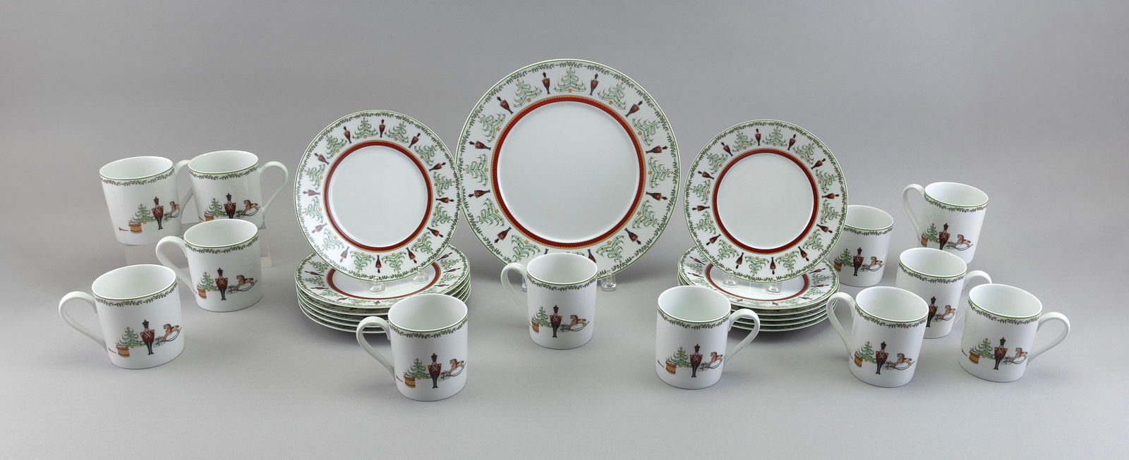 BERNARDAUD "GRENADIERS" PORCELAIN DESSERT SERVICE FOR TWELVE: BERNARDAUD "GRENADIERS" PORCELAIN DESSERT SERVICE FOR TWELVEEach marked on base "Happy Holidays". Consists of:12 dessert plates, diameters 8.25"12 mugs1 cake plate, diameter 10.5"