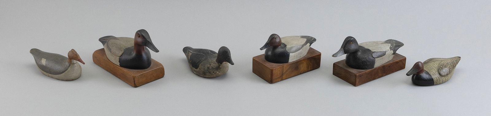 SIX MINIATURE BIRD CARVINGS 20th Century Lengths from 6" to 7".: SIX MINIATURE BIRD CARVINGS20th CenturyA redhead drake by Frank Adams, three divers by Dr. Hill, a goldeneye hen from Cape Cod, and a merganser hen from the North Shore of Massachusetts.Lengths from 6