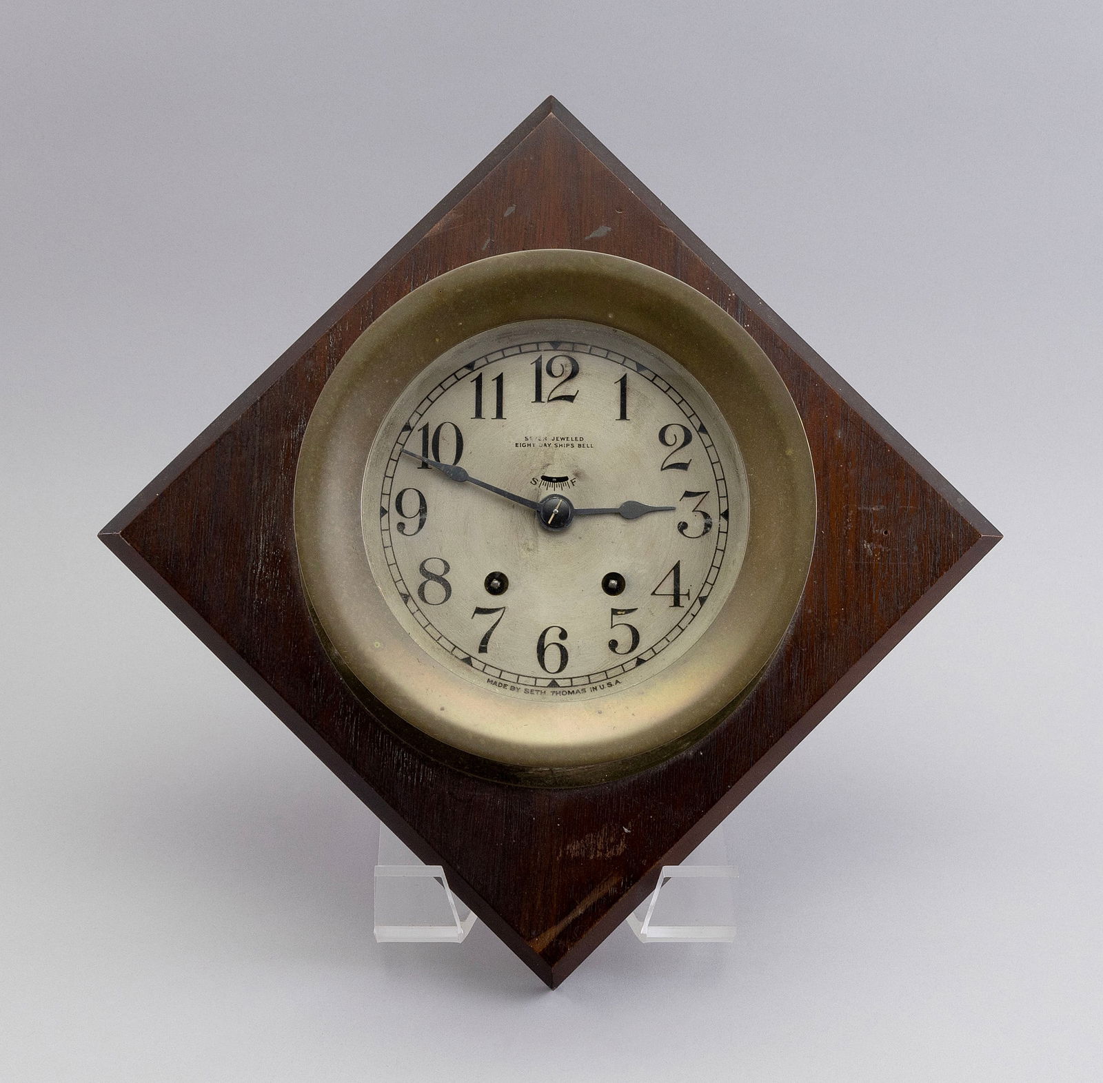 SETH THOMAS EIGHT-DAY SHIP'S BELL CLOCK Early 20th Century Face diameter 5.25". Bezel diameter: SETH THOMAS EIGHT-DAY SHIP'S BELL CLOCKEarly 20th CenturyBrass case. Arabic numeral dial. Face marked "Seven Jeweled", "Eight Day Ship's Bell" and "Made by Seth Thomas in U.S.A.". Service sticker vers