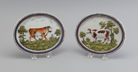 TWO ENGLISH SOFT PASTE PLAQUES DEPICTING COWS 19th Century Both approx. 6.5" x 7.5".