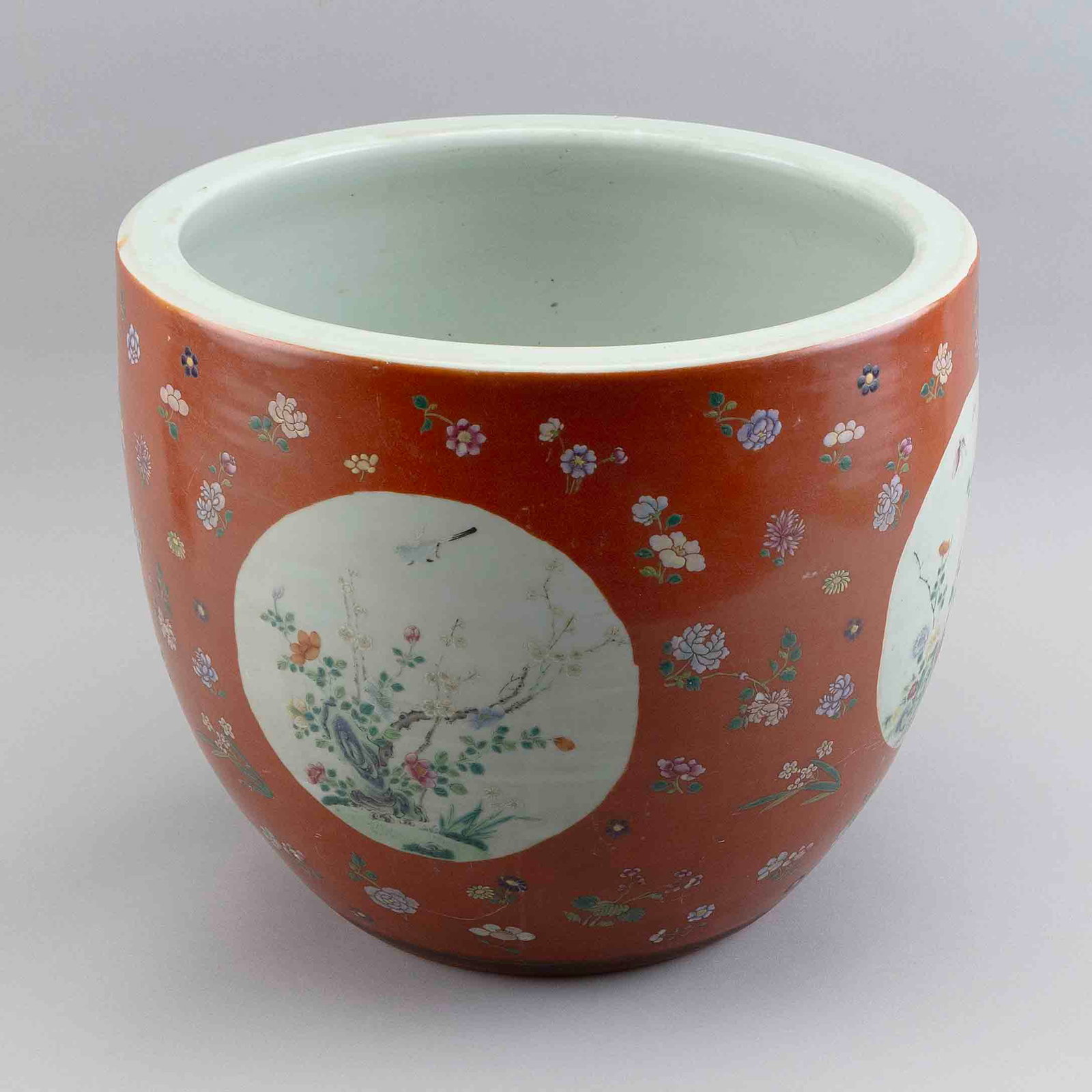 CHINESE FAMILLE ROSE JARDINIERE Late 19th/Early 20th Century Height 12.25". Diameter 14.5".: CHINESE FAMILLE ROSE JARDINIERE Late 19th/Early 20th Century Bird and floral decoration against a coral red ground. Height 12.25". Diameter 14.5".