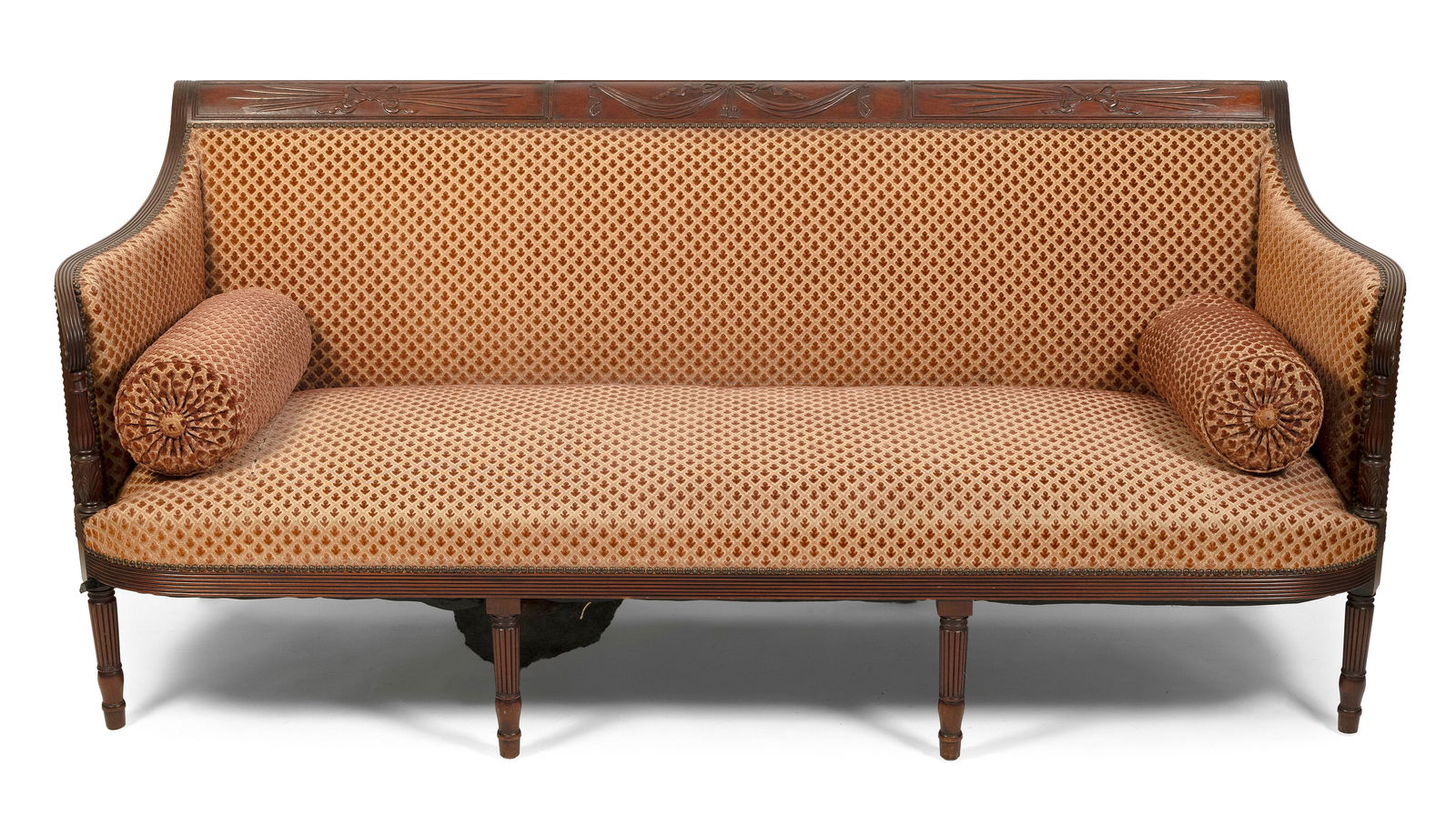 SHERATON FEDERAL SOFA IN THE MANNER OF DUNCAN PHYFE New York, Circa 1810 Back height 36". Seat: SHERATON FEDERAL SOFA IN THE MANNER OF DUNCAN PHYFENew York, Circa 1810Mahogany with tan and burgundy printed upholstery. Relief-carved back panel. Reeded tapered arm supports with acanthus leaf carvi