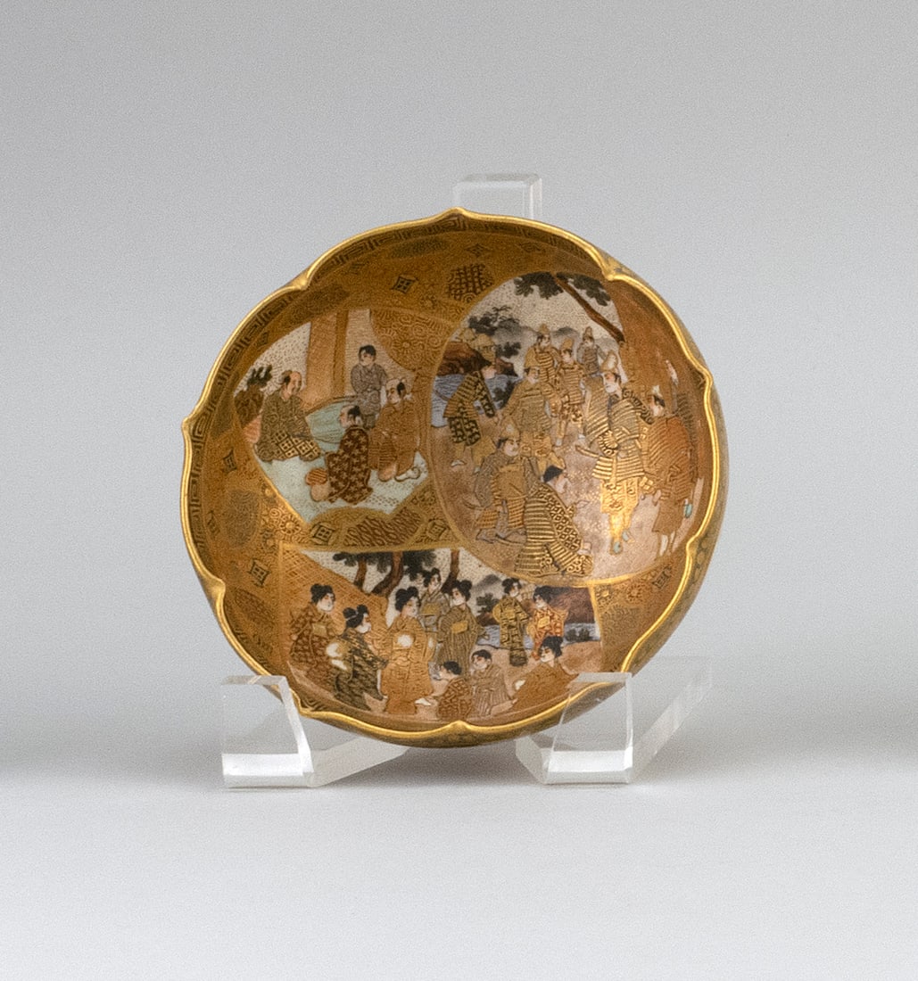 JAPANESE SATSUMA PORCELAIN BOWL Meiji Period Height 2". Width 4.75".: JAPANESE SATSUMA PORCELAIN BOWL Meiji Period Lotus-shaped rim. Exterior and interior with decoration of figural cartouches against a gilt floral and brocade ground. Shimazu crest on signature plaque o