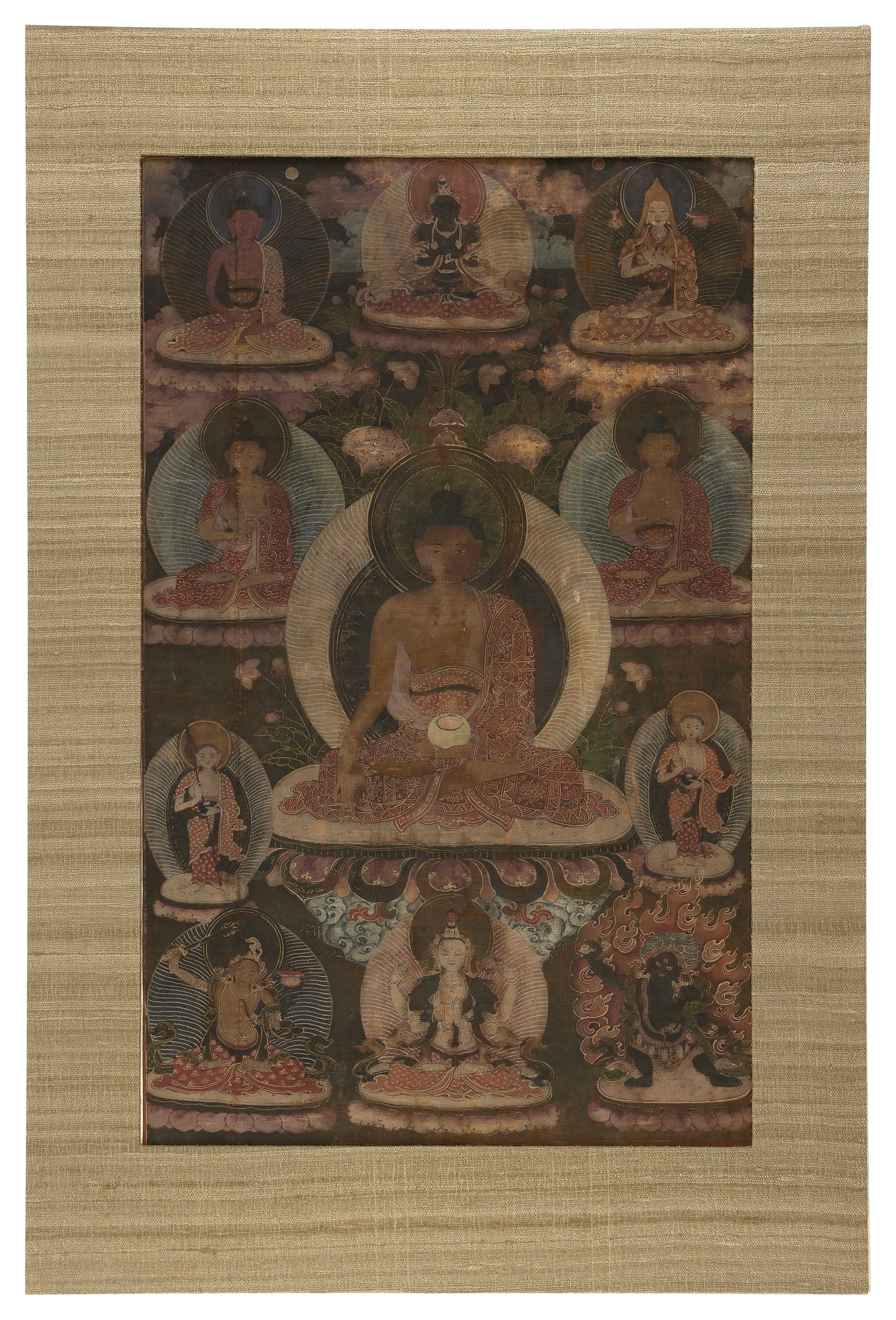 TIBETAN THANGKA 19th Century Pigment on cotton, 26" x 16". Matted 32" x 22".: TIBETAN THANGKA 19th Century Central Buddha surrounded by ten Bodhisattvas among lotus stems and clouds. Pigment on cotton, 26" x 16". Matted 32" x 22".
