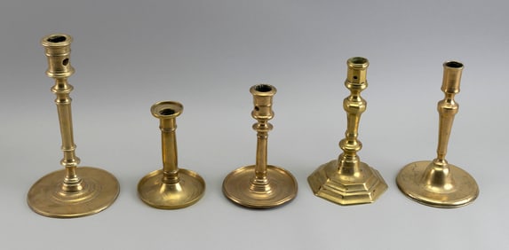 FIVE BRASS CANDLESTICKS America and England, 18th/Early 19th Century Heights from 5.5" to 9.25".