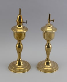 NEAR-PAIR OF BRASS LAMPS America, 19th Century Height to top of fonts 9.25".