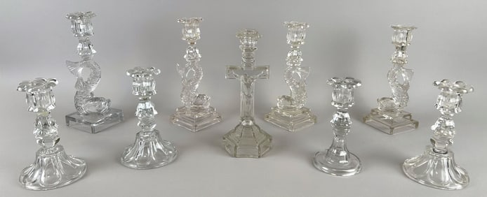 NINE CLEAR PRESSED GLASS CANDLESTICKS 19th Century Heights from 7" to 11".