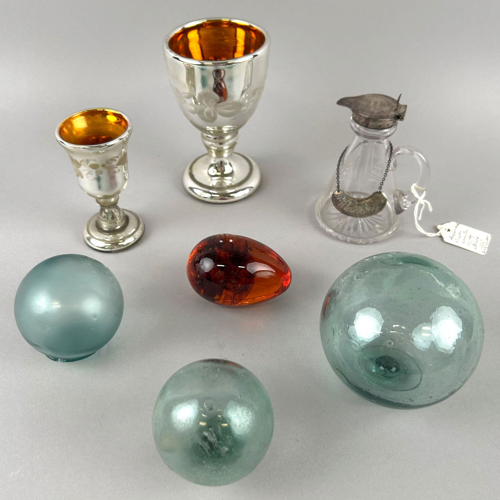 LOT OF GLASS Heights to 4.75".: LOT OF GLASSTwo mercury glass cups, an egg, a cruet and three balls.Heights to 4.75".