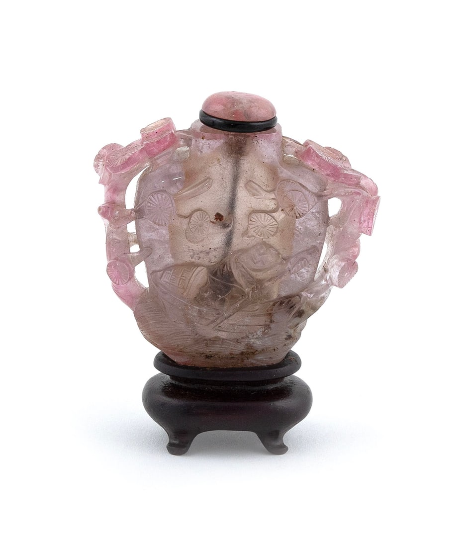 CARVED PINK QUARTZ SNUFF BOTTLE Late 19th Century Height 2".: CARVED PINK QUARTZ SNUFF BOTTLE Late 19th Century Ovoid form. Decoration of boatmen on a river and openwork prunus branches. Replaced pink stone stopper. Affixed to a wood stand. Height 2".