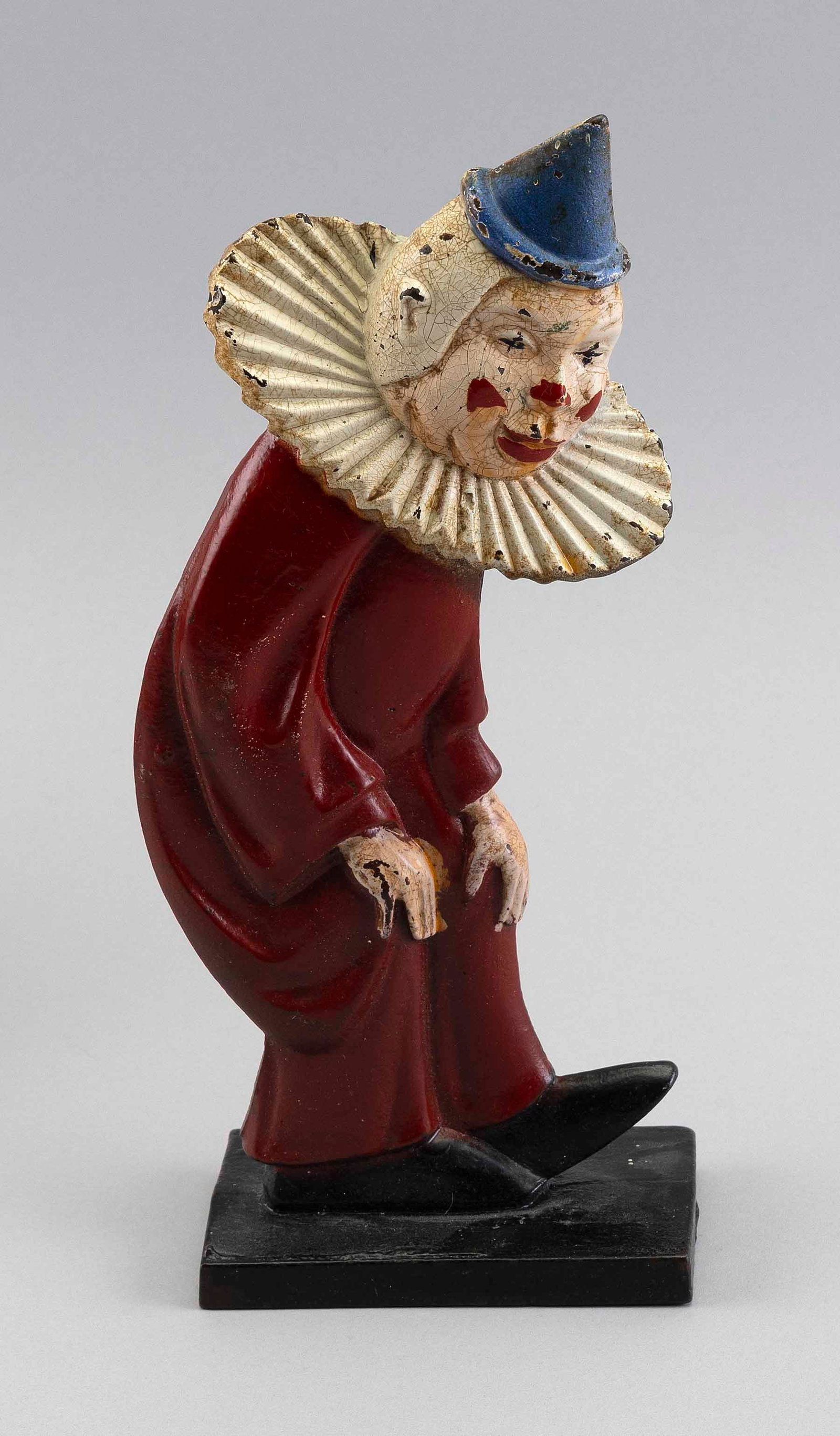 HUBLEY CAST IRON CLOWN DOORSTOP WITH ORIGINAL PAINT Lancaster, Pennsylvania, Circa 1920 Height: HUBLEY CAST IRON CLOWN DOORSTOP WITH ORIGINAL PAINT Lancaster, Pennsylvania, Circa 1920 Double-sided flattened full-bodied form. Height 10.25". Provenance: An Upstate New York Collection. Illustra