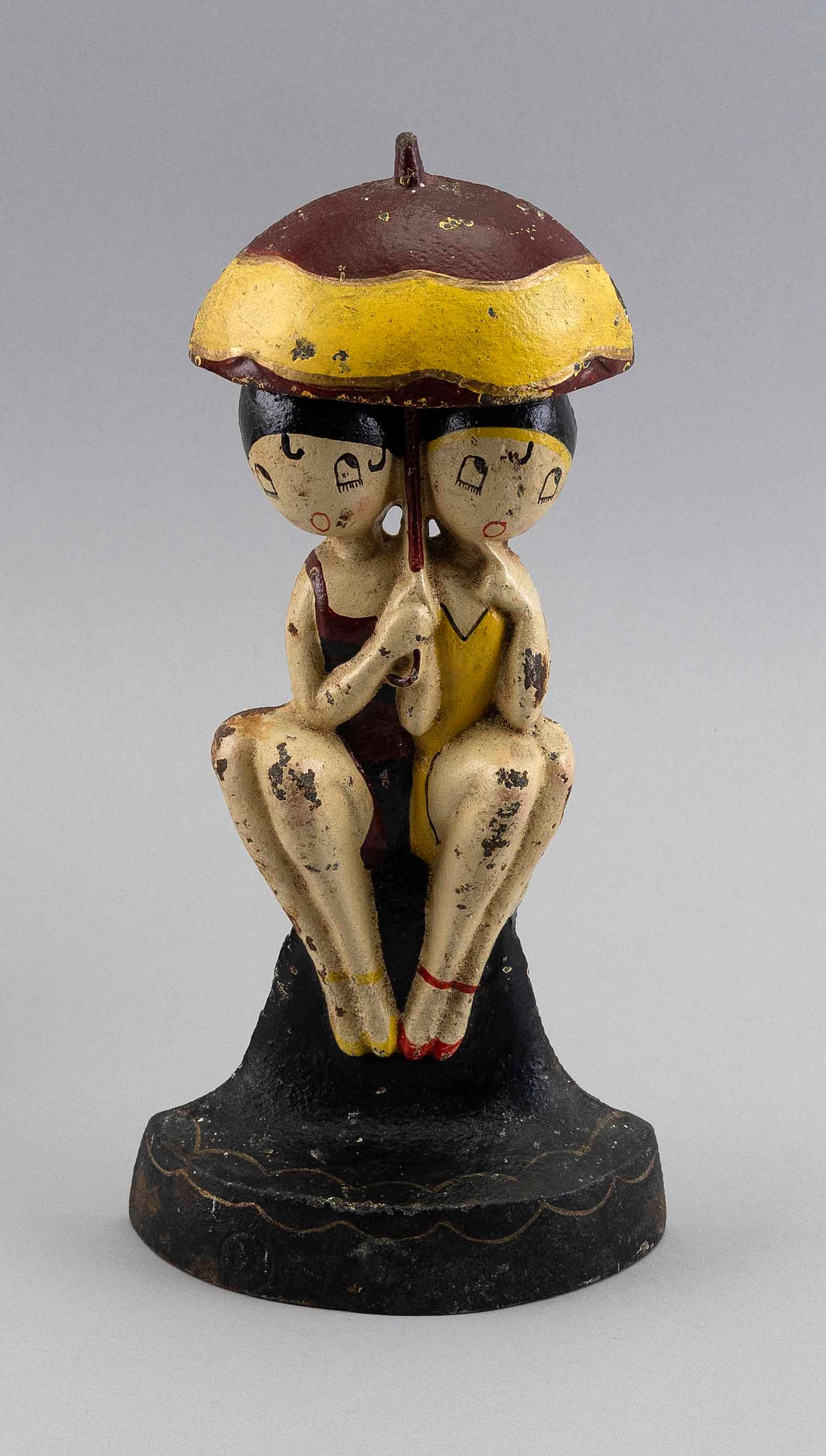 ANNE HARRIET FISH (SEFTON) FOR HUBLEY CAST IRON "BATHING BEAUTIES" DOORSTOP Lancaster, Pennsylvania,: ANNE HARRIET FISH (SEFTON) FOR HUBLEY CAST IRON "BATHING BEAUTIES" DOORSTOP Lancaster, Pennsylvania, Early 20th Century Beauties holding a yellow and brown painted umbrella and seated on a black base.