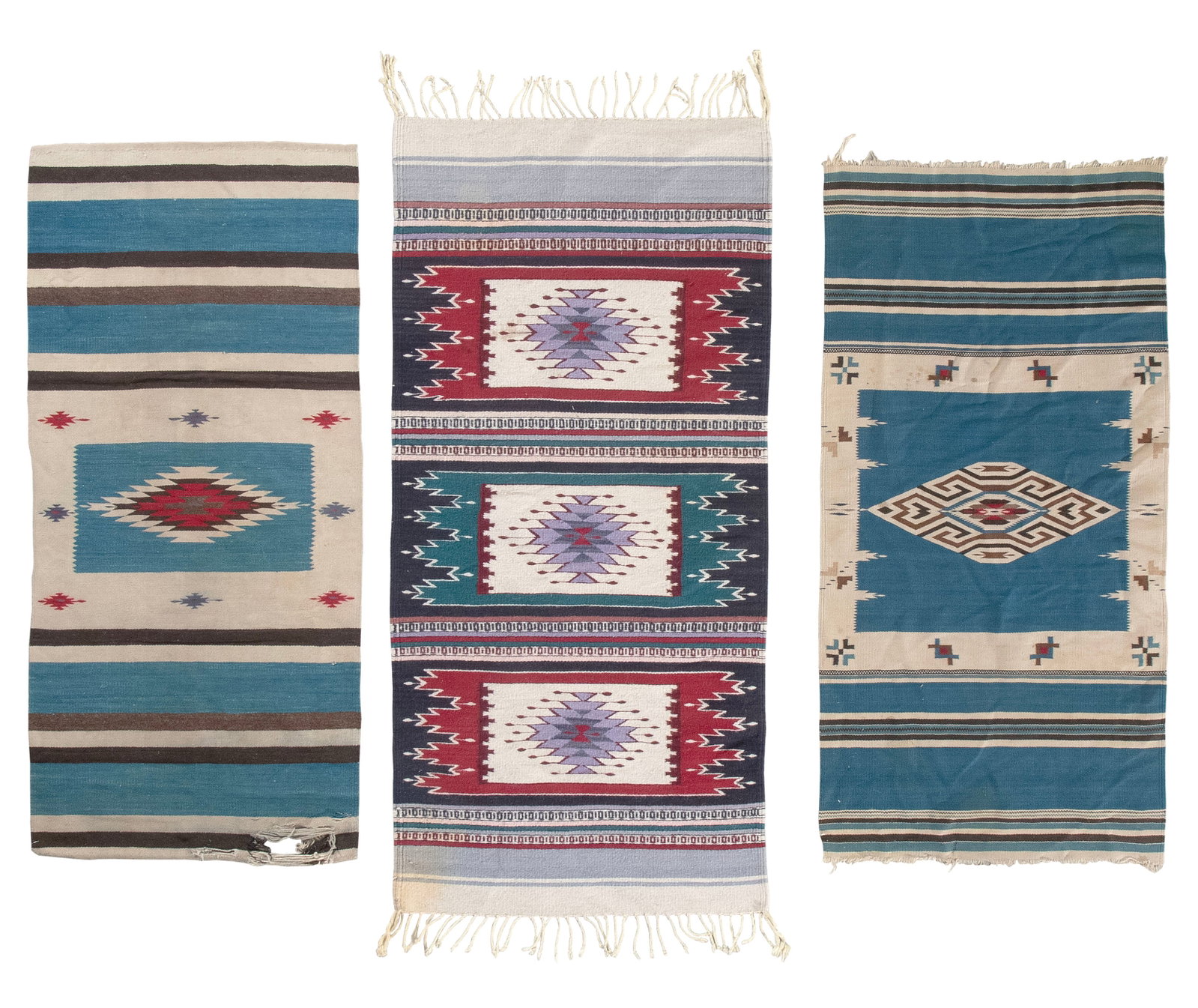 THREE NATIVE AMERICAN OR MEXICAN RUGS Late 20th Century From 2'4" x 4'8" to 2'6" x 5'4".: THREE NATIVE AMERICAN OR MEXICAN RUGS Late 20th Century Two with blue, brown and ivory bands bracketing a central medallion on a blue field. The other with multiple narrow stripes alternating with bol