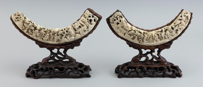 PAIR OF CHINESE EXPORT RELIEF-CARVED BOAR'S TUSKS 19th Century Heights on stands 8". Lengths 9.5".