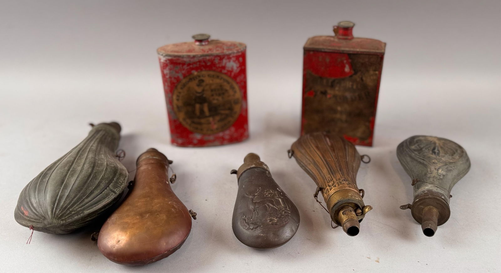 FIVE ENGLISH POWDER FLASKS AND TWO GUNPOWDER TINS 19th Century Lengths from 4" to 8".: FIVE ENGLISH POWDER FLASKS AND TWO GUNPOWDER TINS19th CenturyLengths from 4" to 8".