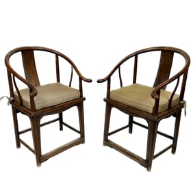 PAIR OF CHINESE ELMWOOD HORSESHOE-BACK CHAIRS Late 18th/Early 19th Century Back heights 38.75". Seat
