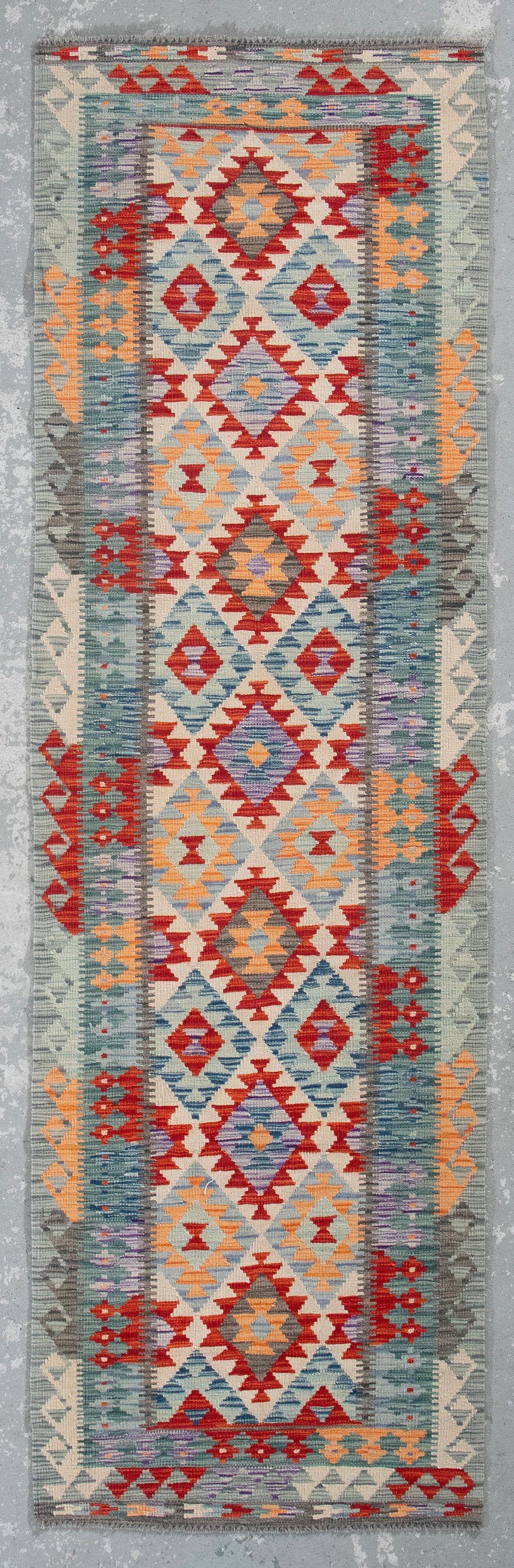 KILIM DESIGN RUNNER: 3'0" X 9'8" 21st Century: KILIM DESIGN RUNNER: 3'0" X 9'8" 21st Century Field composed of a series of contiguous diamonds in shades of ivory, crimson, light blue, violet and peach, each containing rudimentary geometric element