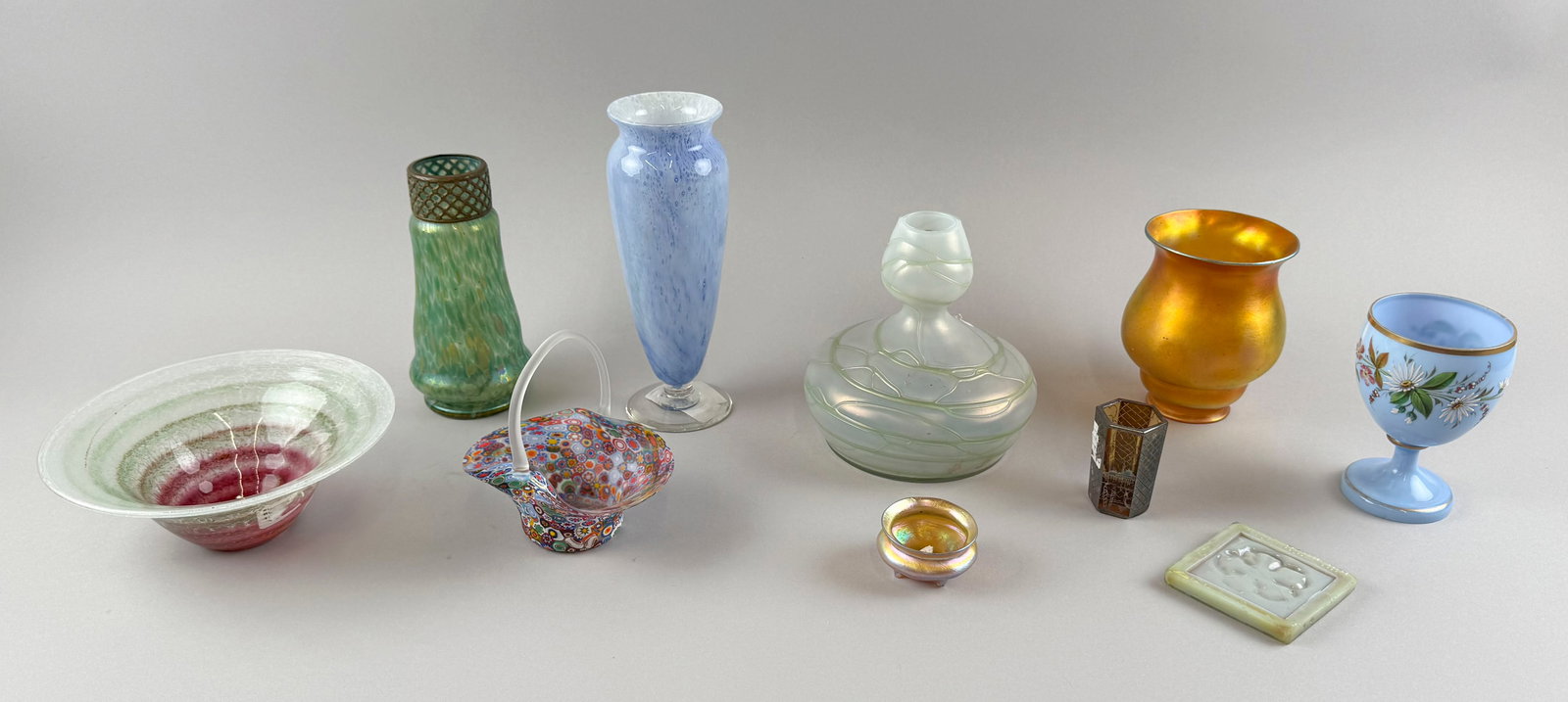 TEN PIECES OF GLASS Early 20th Century: TEN PIECES OF GLASS Early 20th Century 1) Bowl, diameter 7.5". 2) Iridescent vase with brass collar, height 7". 3) Tiffany salt. 4) Enameled goblet. 5) Pallme-Konig-style vase, height 6.5". 6) Durand 
