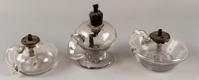 THREE CLEAR BLOWN GLASS SPARKING LAMPS Early 19th Century Heights from 1.5" to 3".