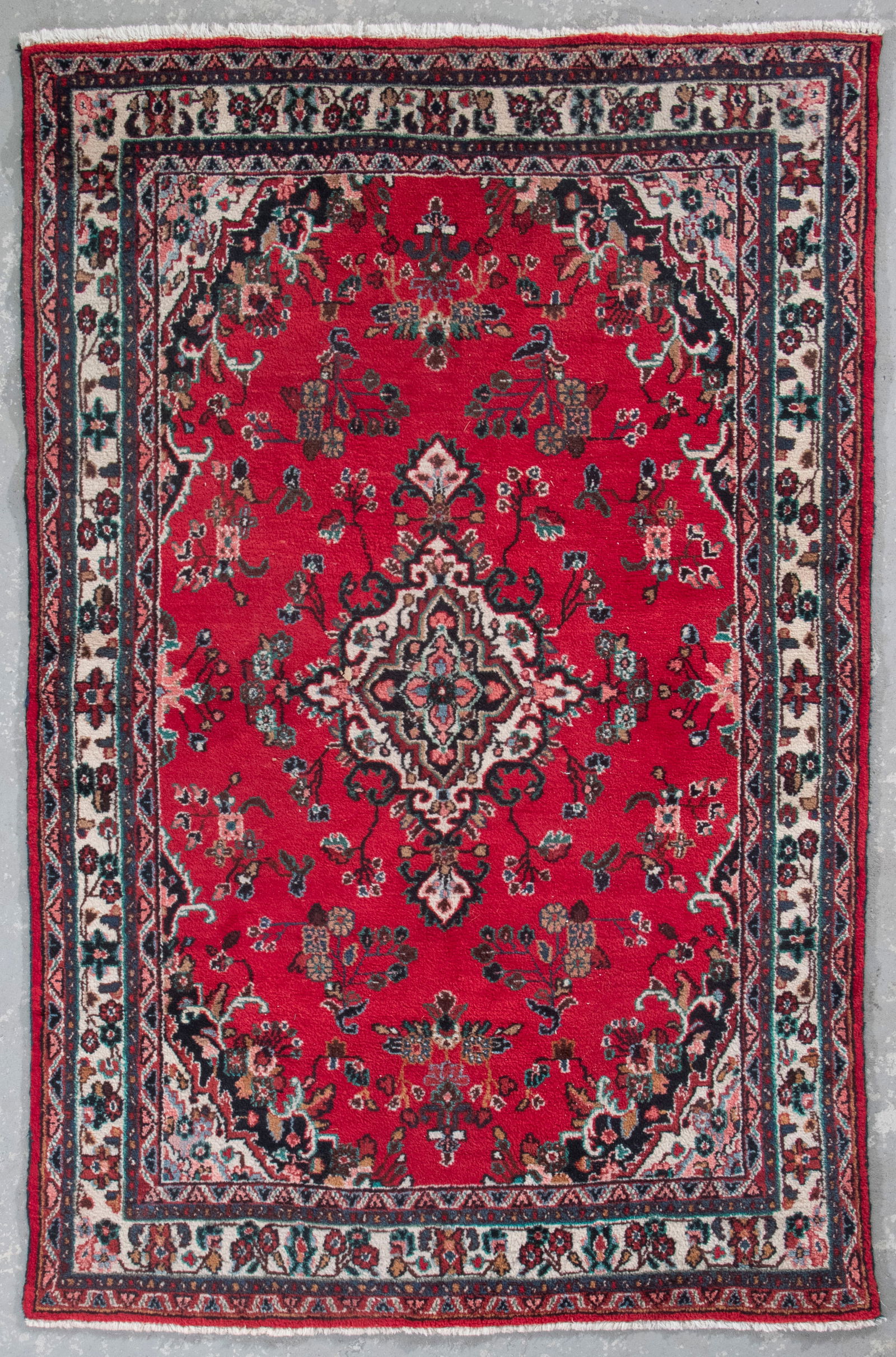 HAMADAN RUG: 6'2" X 9'4" Second Quarter of the 20th Century: HAMADAN RUG: 6'2" X 9'4"Second Quarter of the 20th CenturyA central ivory medallion is surrounded by blue and onyx branches bearing pastel colored blossoms on a red field. A quartered medallion echoin