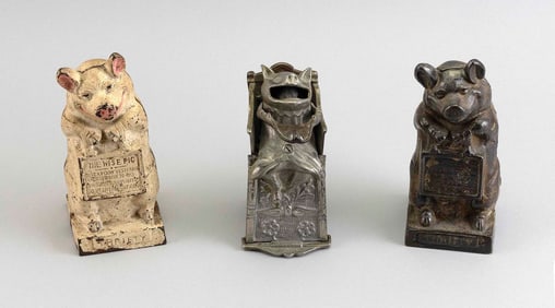 THREE CAST IRON BANKS Early 20th Century Heights from 6" to 7".