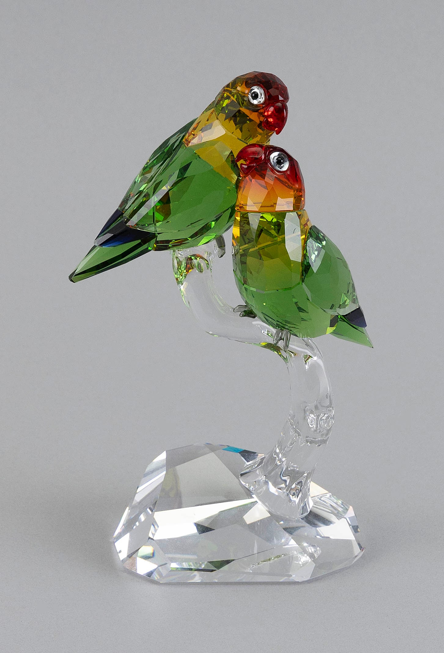 SWAROVSKI CRYSTAL "LOVEBIRDS" Austria, Late 20th Century Height 6.5".: SWAROVSKI CRYSTAL "LOVEBIRDS" Austria, Late 20th Century Colorful birds perched on a clear branch. Signed on base. Height 6.5". Provenance: An Upstate New York Collection.