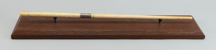 TURNED BONE BATON 19th Century Length 21.25". On a contemporary wooden stand.