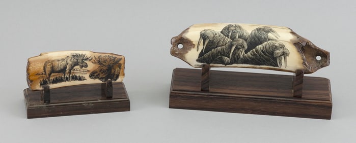 TWO ENGRAVED FOSSILIZED WALRUS TUSKS BY ROBERT MONFILS 20th Century Lengths 4.5" and 7". On