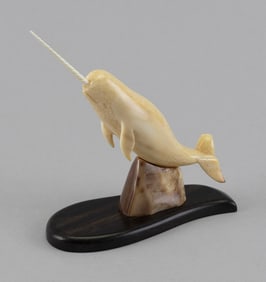 CARVED FOSSILIZED IVORY NARWHAL BY AL DOUCETTE 20th Century Height 4.75". Length 5.25".