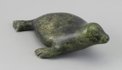 INUIT CARVED SOAPSTONE SEAL Kinngait (Cape Dorset), Nunavut, 20th Century Height 4". Length 12.5".