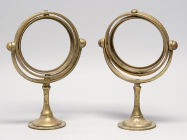 PAIR OF BRASS LAMP GIMBALS Late 19th/Early 20th Century Heights 7.5". Opening diameter 4.75".