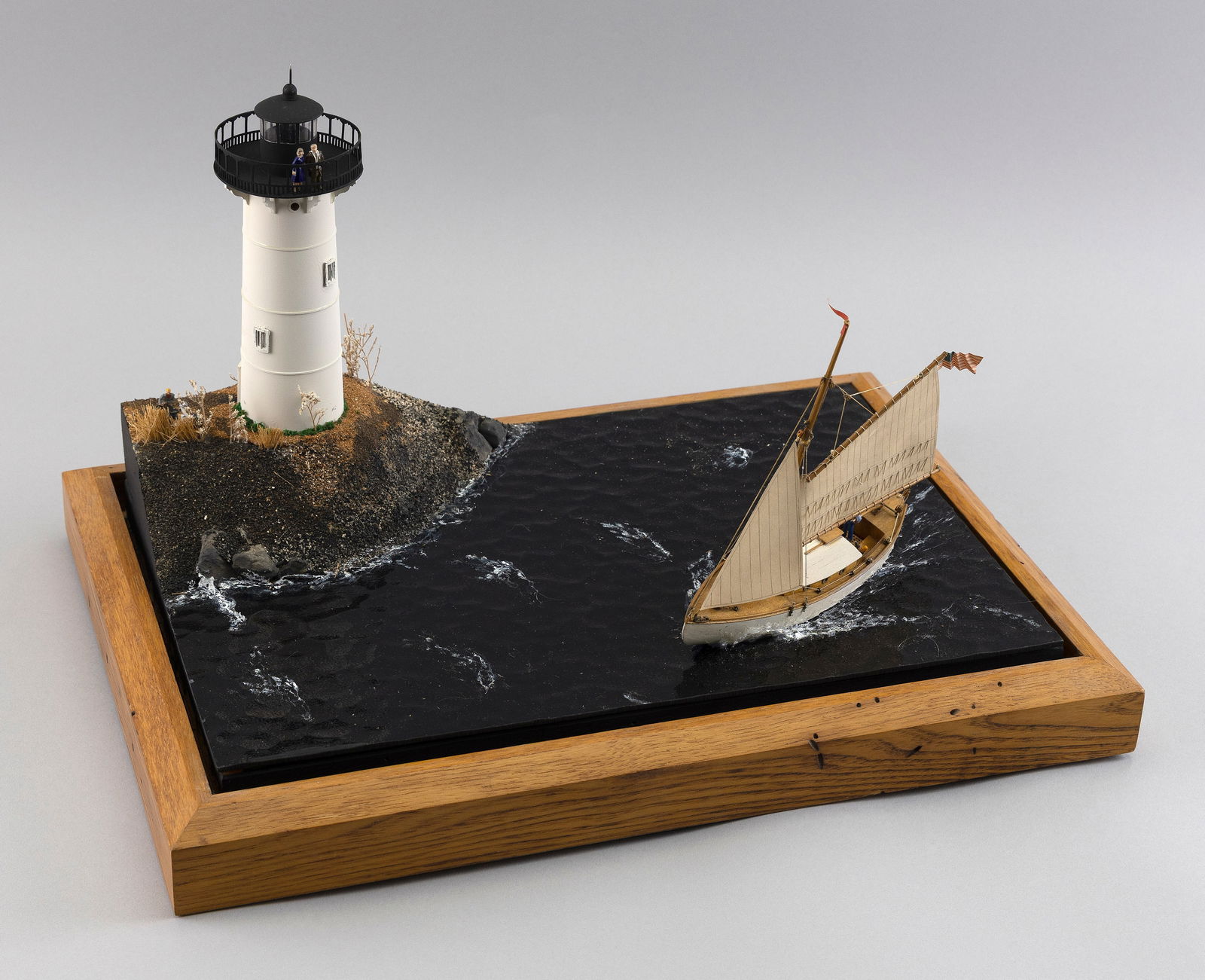 BOAT AND LIGHTHOUSE DIORAMA: BOAT AND LIGHTHOUSE DIORAMACase dimensions: Height 11.75". Width 17.125". Depth 12.125".